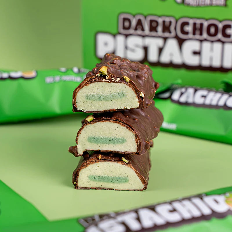 Wispy Dark Choco Pistachio bars cut and stacked showing green pistachio center, chocolate coated