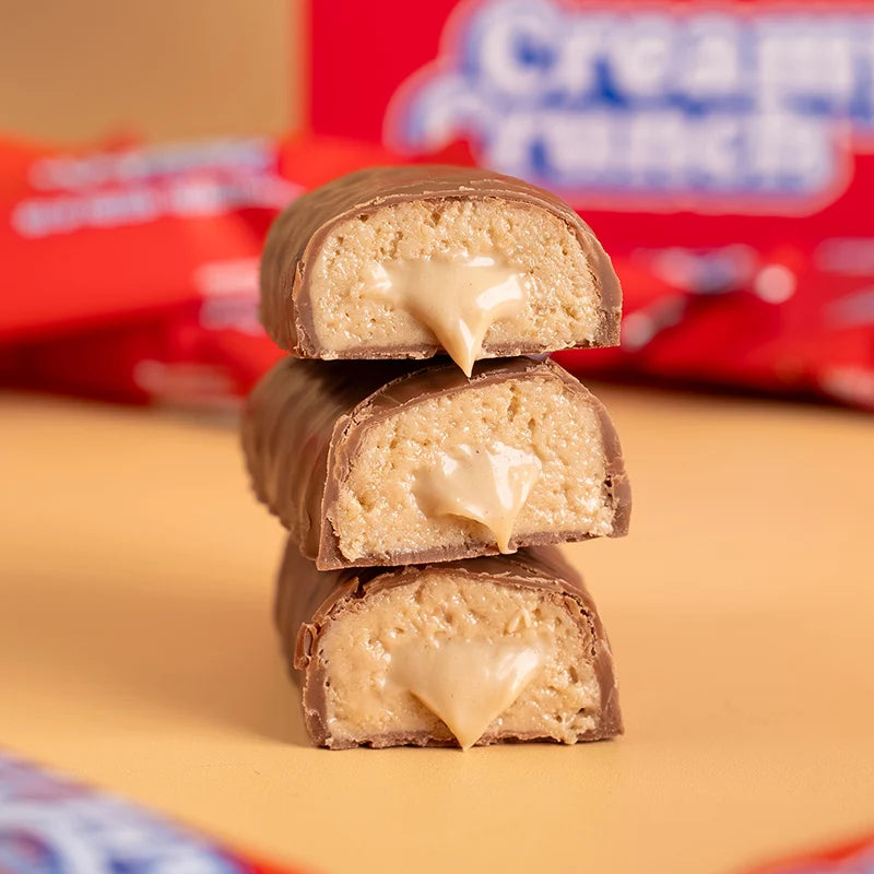 Wispy Creamy Crunch bars cut and stacked showing soft caramel center, milk chocolate coating
