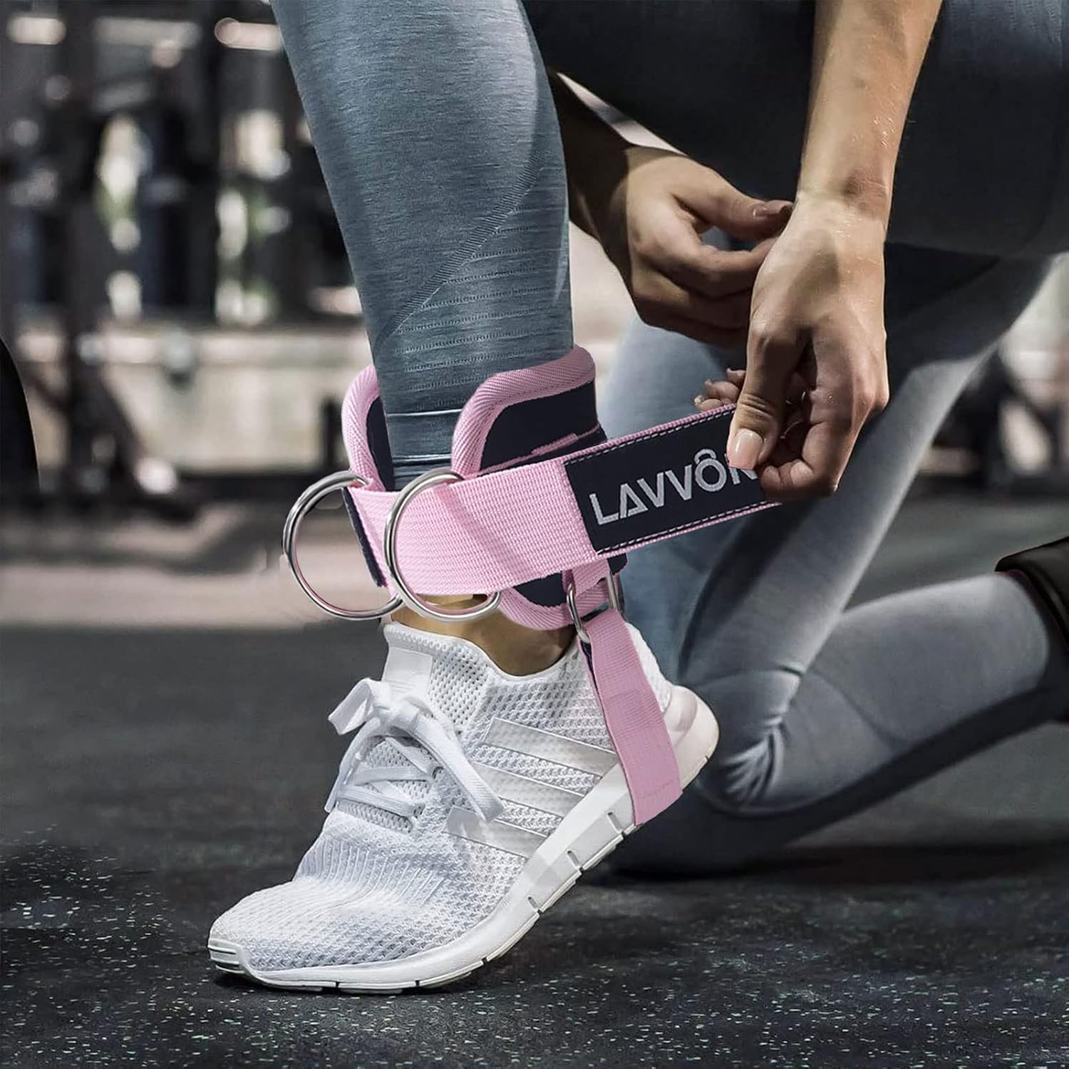 Padded ankle strap clipped to a low cable pulley for controlled glute kickbacks on a cable machine
