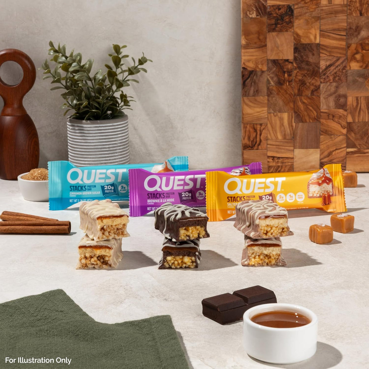 Quest Nutrition Stacks protein bars in three flavours with cut bars on a kitchen counter lifestyle shot