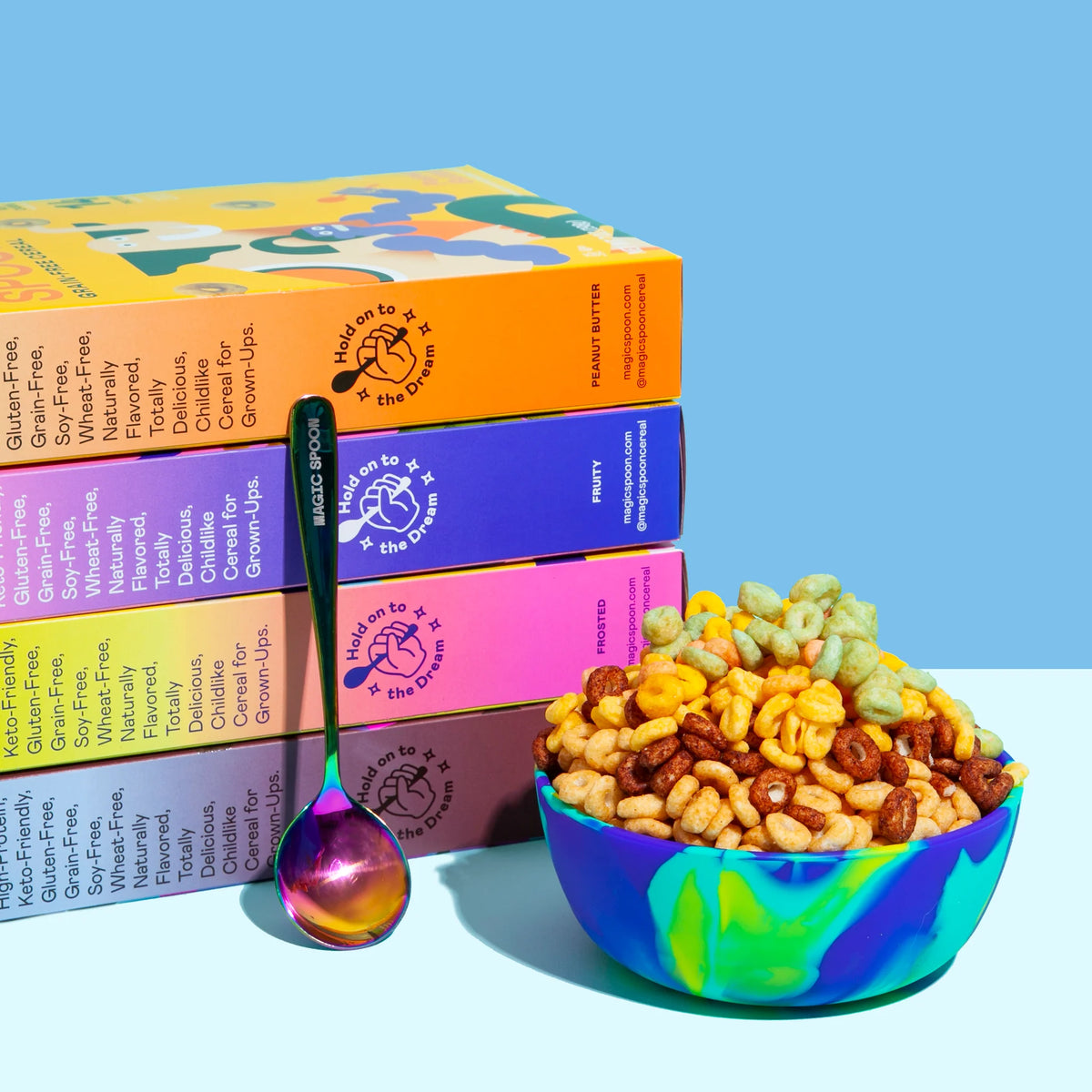 Magic Spoon Protein Cereal boxes stacked to show grain-free and gluten-free benefits beside a bowl of cereal