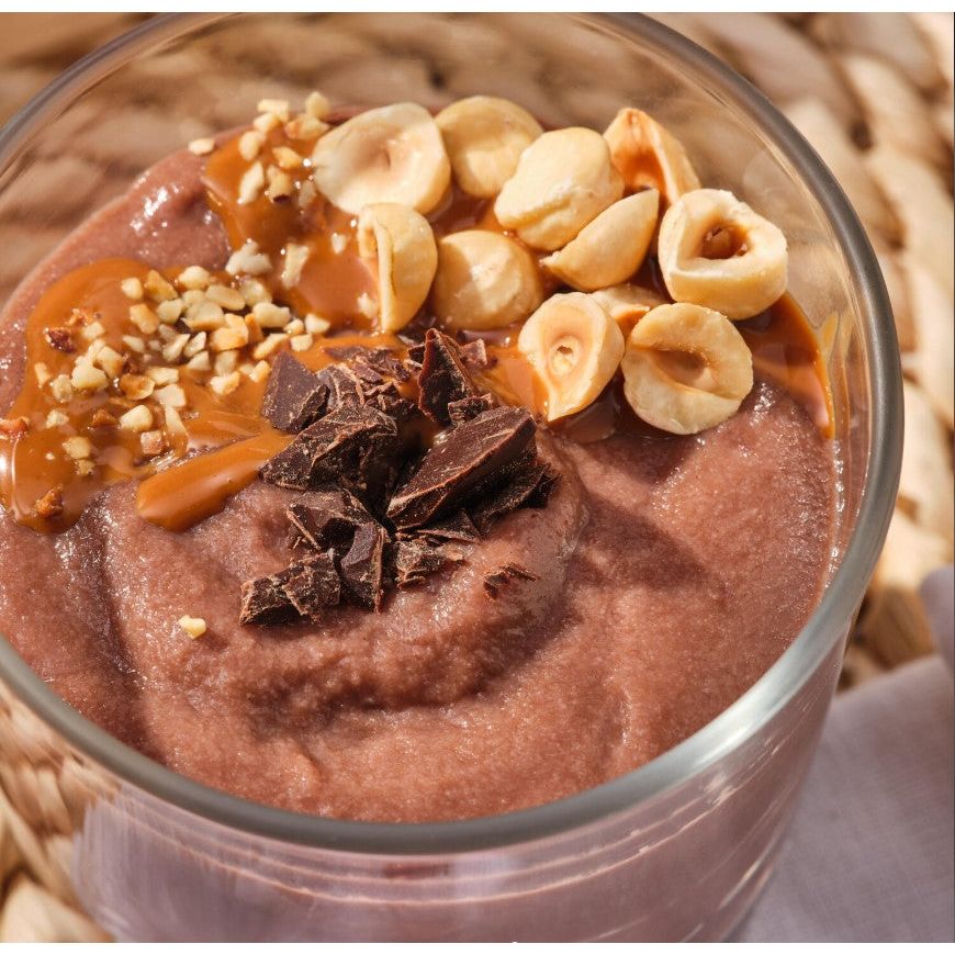 Prozis Vegan Sugar Free Rice Porridge — glass of chocolate porridge topped with hazelnuts and chocolate