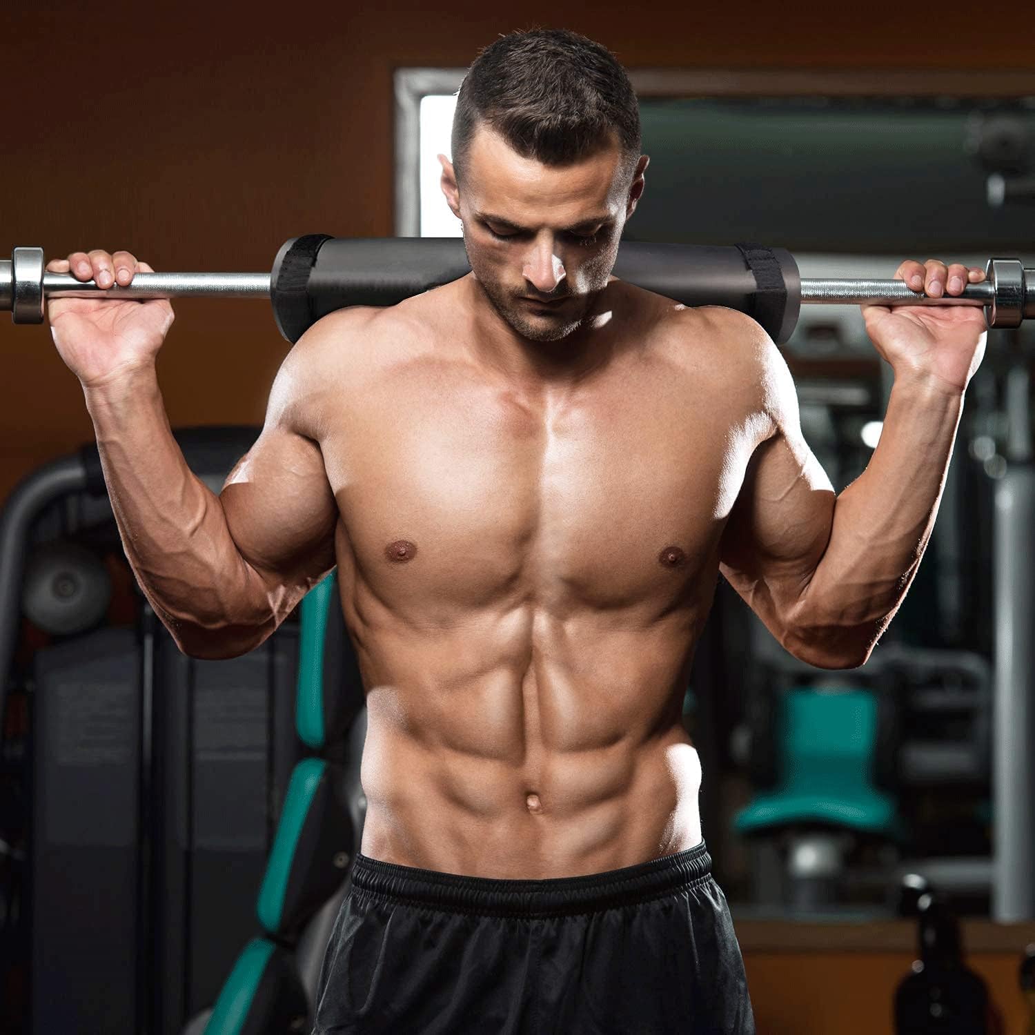 Barbell pad cushioning the shoulders during a loaded back squat for comfortable heavy leg-day training