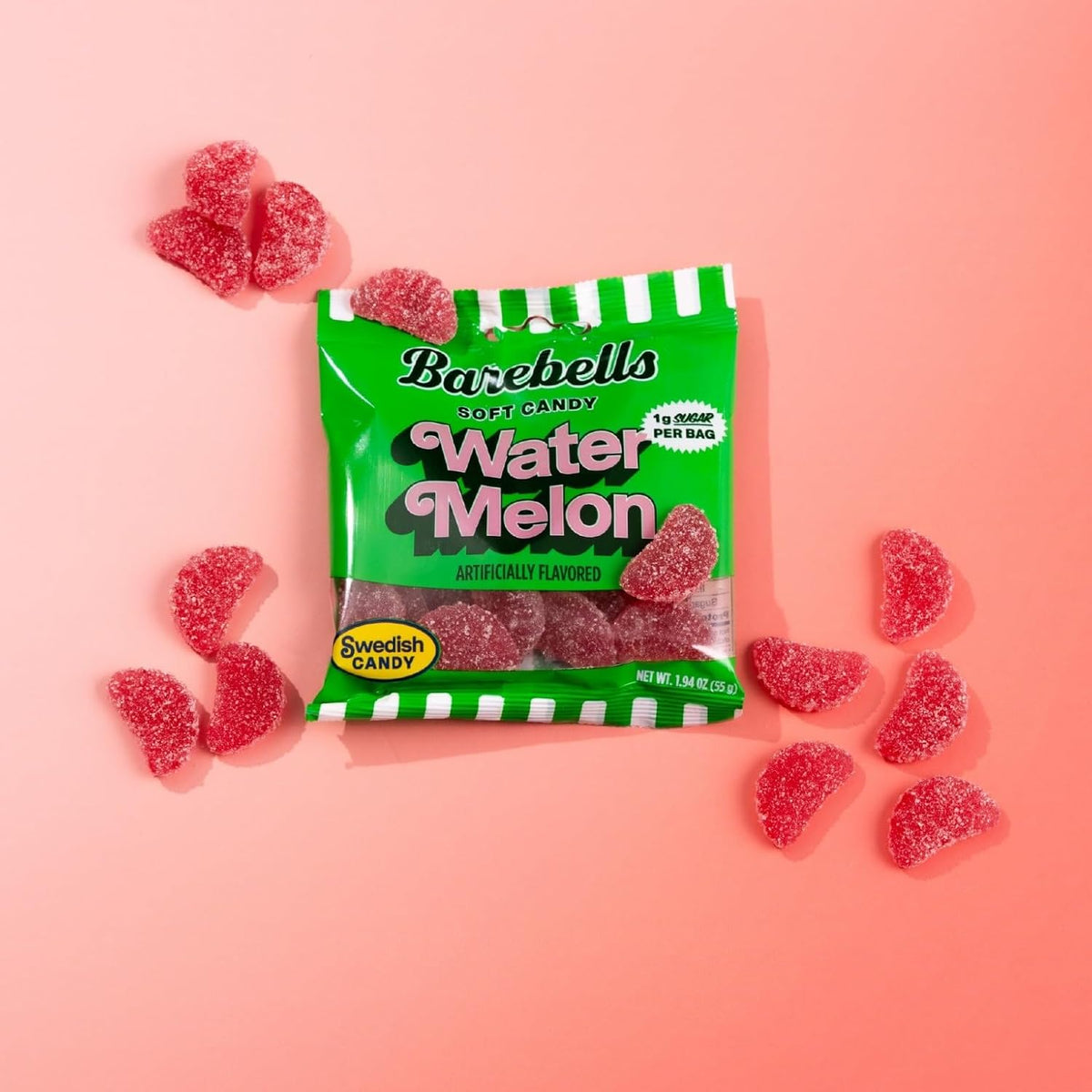 Barebells Soft Candy Watermelon bag with sugar-coated watermelon slice gummies on a pink background