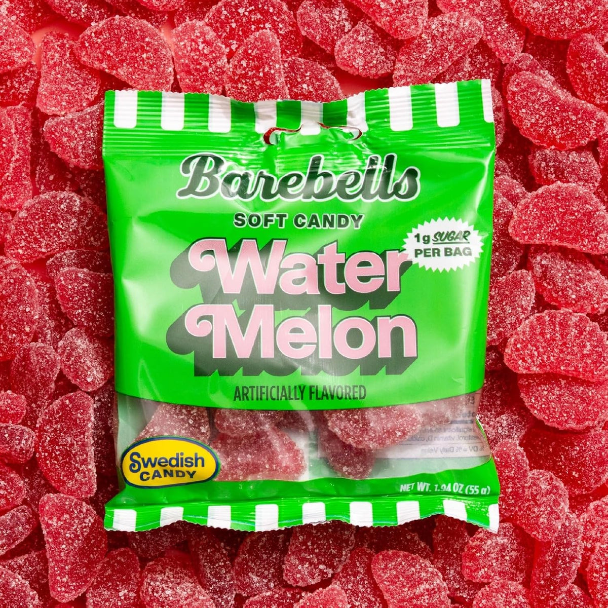 Barebells Soft Candy Watermelon gummy bag resting on a pile of sugar-coated watermelon candies