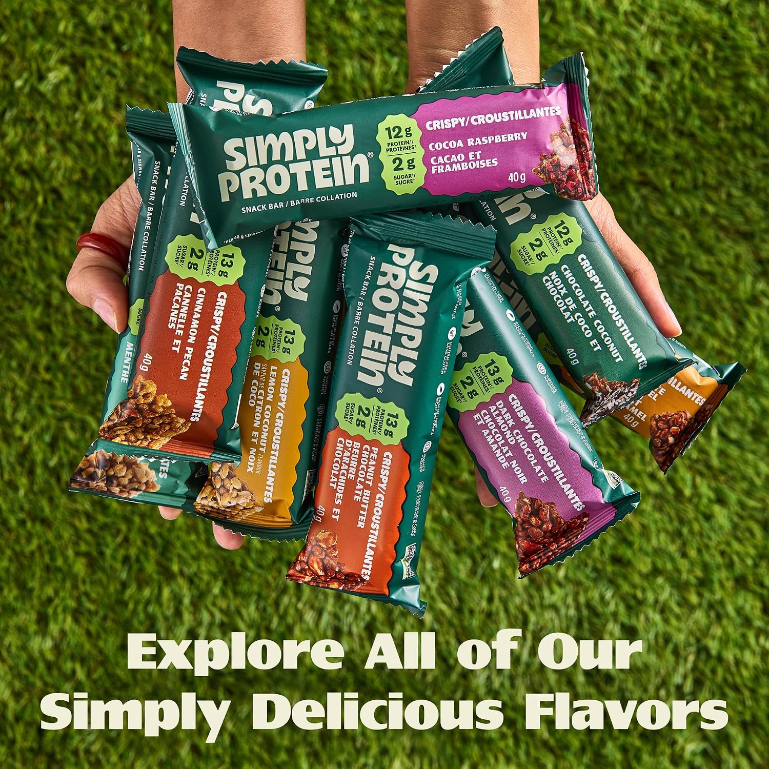 SimplyProtein Vegan Protein Bars fanned out and held in hand — explore the full plant-based bar range
