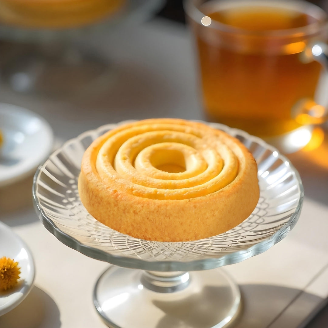 Diablo No Added Sugar Butter Cookie styled on a glass cake stand beside a cup of tea