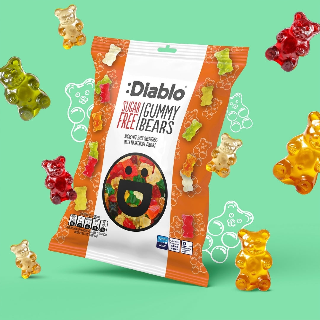 Diablo Sugar Free Gummy Bears 75g bag surrounded by scattered red, green and yellow fruit gummy bears