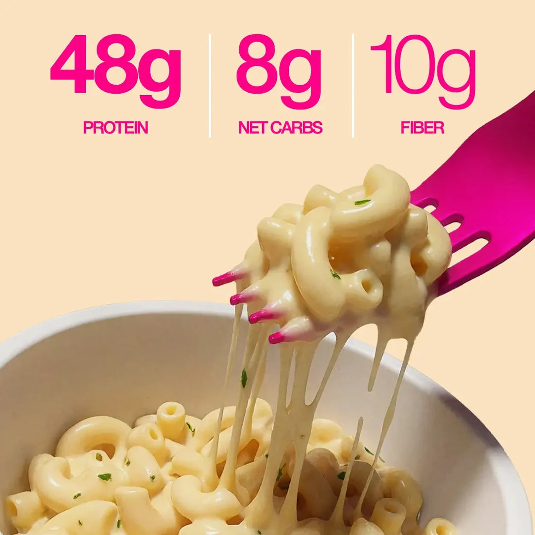 Close-up of Legendary Garlic Parmesan protein pasta on a fork with cheese stretch: 48g protein, 8g net carbs, 10g fibre.