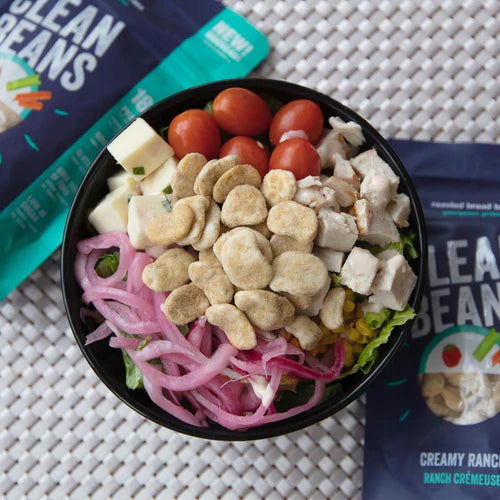Nutraphase Clean Beans roasted broad beans on a salad bowl with chicken and pickled red onion