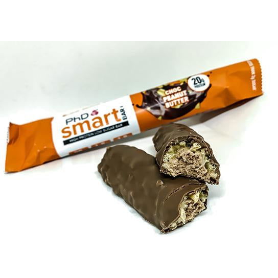 PhD Smart Choc Peanut Butter bar cut in half showing caramel, orange wrapper behind, 20g protein