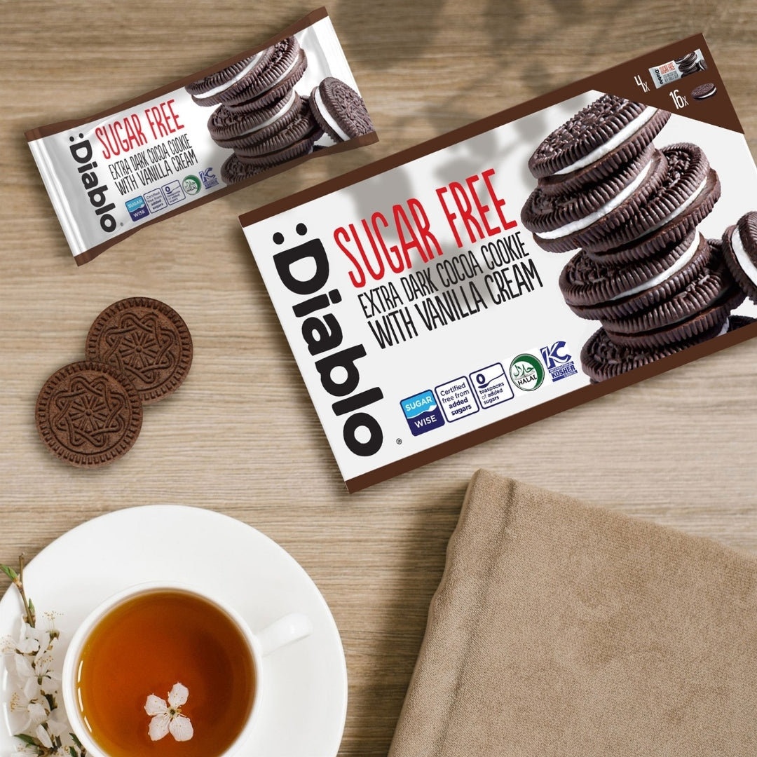 Diablo Sugar Free Extra Dark Sandwich Cookies 176g box and single pack beside a cup of tea, serving idea
