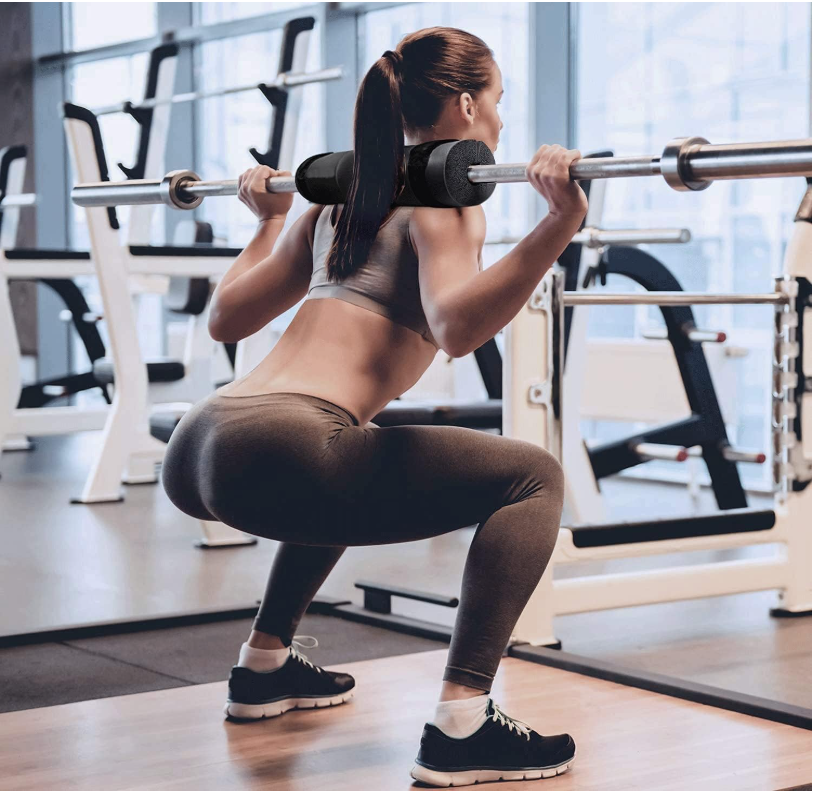 Barbell pad cushioning the neck and shoulders during a loaded barbell squat