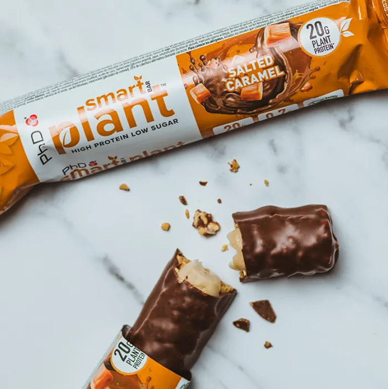 PhD Smart Plant Salted Caramel vegan protein bar on marble with broken piece, 20g plant protein