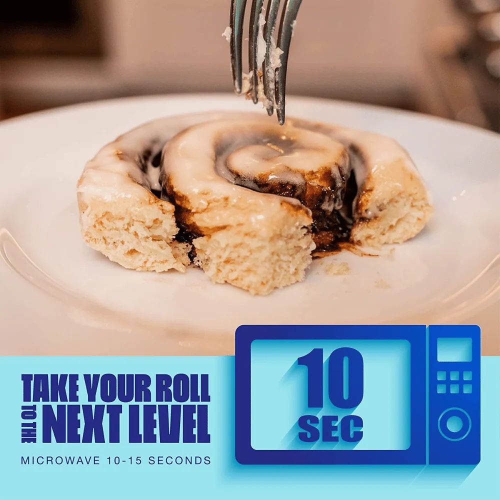 Fork lifting a warm iced Legendary Cinnamon Protein Sweet Roll from a plate, ready in 10 seconds