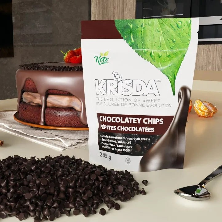 Krisda Semi-Sweet Chocolatey Chips pouch on kitchen counter beside a chocolate layer cake and loose chips