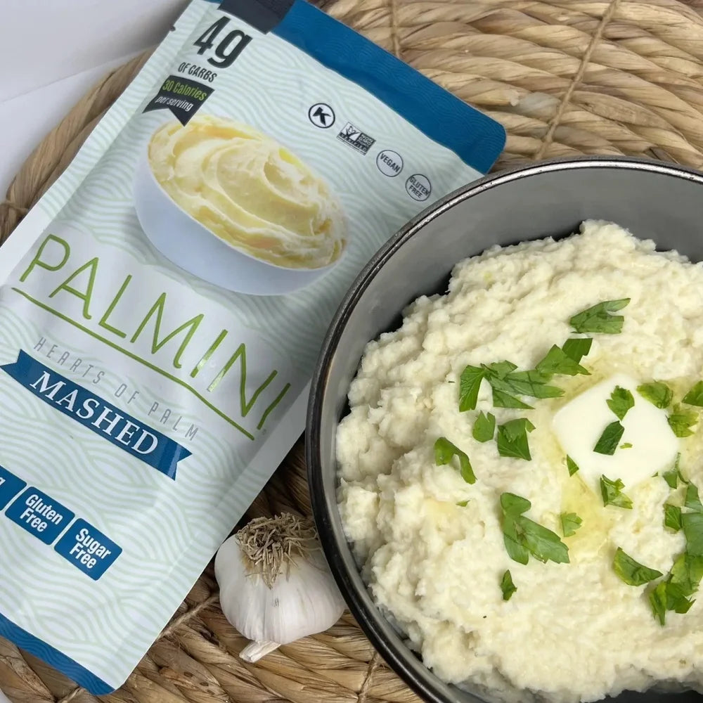 Palmini Hearts of Palm Mashed pouch beside a bowl of mash topped with butter, parsley and garlic