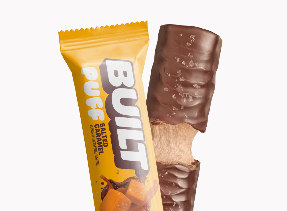 Built Salted Caramel Protein Puff single bar in and out of wrapper on white — 17g protein, low sugar